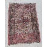 A pink ground Persian rug 49" x 31"There is some light staining and the fringe is missing to 1 end