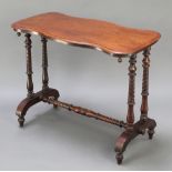 A Victorian shaped mahogany stretcher table, the top of serpentine outline raised on turned supports