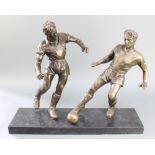 A bronzed figure group of 2 standing footballers, raised on a rectangular black marble base 20"h x