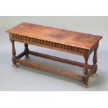 A rectangular oak stool with arcaded decoration, raised on turned and block supports 18"h x 39"w x