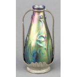 An Art Nouveau iridescent bottle vase contained within a pewter mount with twin handles 6" The