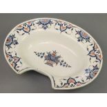 A 19th Century Delft shaving bowl with stylised floral motifs surrounding a basket of flowers 14"