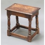 A rectangular oak joined stool raised on turned and block supports 18"h x 18"w x 11"dThere is a