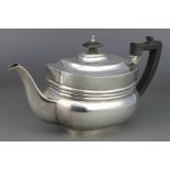 A rounded rectangular silver teapot with ebony mounts London 1926, gross 700 grams