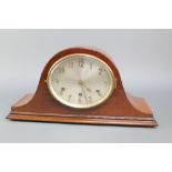 A chiming mantel clock with oval silvered dial and gilt Arabic numerals, contained in a mahogany