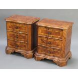 A pair of Queen Anne style walnut bedside chests of serpentine outline with crossbanded tops