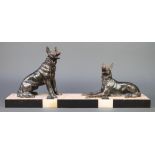 An Art Deco spelter and 3 colour marble figure group of 2 seated alsatians, raised on a 3 colour