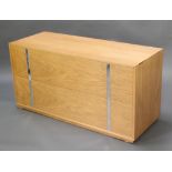 J M Design Company, a mid Century light oak and chrome mule chest with hinged lid, the base fitted a