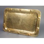 A rectangular Newlyn style brass tray with roundelled and planished decoration 15" x 23 1/2"