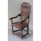 An 18th Century carved and inlaid oak Wainscot chair with geometric carved decoration and scroll