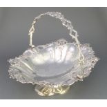 A Victorian cast and chased silver basket with swing handle and presentation inscription