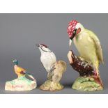 A Beswick figure Woodpecker on branch 1218 9 1/2", a ditto of a Lesser Spotted Woodpecker 2420 6"