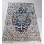 A white and blue ground Persian Nain rug with central medallion with multi row borders 84" x 57"