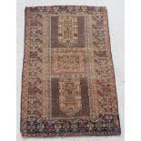 A brown ground Belouche rug with rectangular medallion to the centre within multi row borders 56"