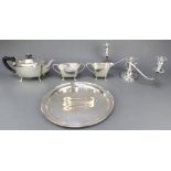 A silver plated 3 piece tea set, a 3 light candelabrum, pair of nips and a tray