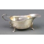 A silver sauce boat of plain form on pad feet, Chester 1936 104 grams