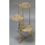 A Victorian style pierced gilt metal 3 tier plant stand decorated birds, raised on outswept supports