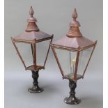 A pair of Victorian style copper and aluminium external lamp houses of waisted form, raised on
