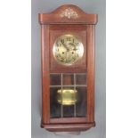 A 1930's chiming wall clock with silvered dial and Arabic numerals contained in an oak case