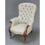 An early Victorian mahogany show frame tub back armchair upholstered in buttoned material, raised on