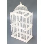 A Continental white painted and wire work domed bird cage 29 1/2"h x 15"w x 8 1/2"d The dome to