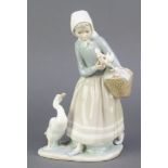 A Lladro figure of a girl with a basket and geese 9" This lot is in good condition.
