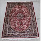 A red and gold ground Belgian cotton Keshan style carpet with central medallion 91" x 63"