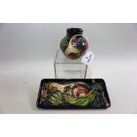 A MILLENIUM MOORCROFT POTTERY BLUE GROUND VASE of compressed circular form decorated with fruit,