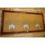 AN EDWARDIAN ART NOUVEAU EMBROIDERED PANEL depicting three peacocks, 23 1/2 ins x 53 1/2 ins in a