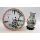 A 20TH CENTURY CHINESE PORCELAIN PLATE decorated in  polychrome enamels with two ladies in a