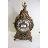 A 19TH CENTURY FRENCH BOULLE MANTLE CLOCK, the red tortoiseshell and cut brass case with putti