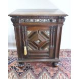 A 19TH CENTURY JACOBEAN REVIVAL OAK SIDE CABINET, the projecting top above a bone and nacre inlaid