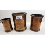A SET OF THREE GEORGIAN BRONZE CYLINDRICAL MEASURES inscribed WIMBOTSOM & STOW, George White &