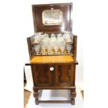 A GOOD QUALITY 1920/30'S OAK DRINKS CABINET, the hinged top above a foliate carved and panelled