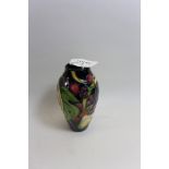 A MILLENIUM MOORCROFT POTTERY BLUE GROUND VASE of ovoid form decorated with fruit, leaves and