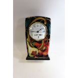 A MILLENIUM MOORCROFT POTTERY BLUE GROUND MANTLE CLOCK decorated with fruit, leaves and berries,