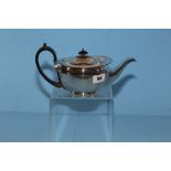 A GEORGE V SILVER TEAPOT of ovoid form, with ebonised handle and knop, presentation inscription,