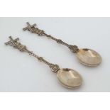 A pair of Dutch silver teaspoons the handles formed as windmills with articulated sails.