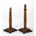 Two 1960's carved teak wood table lamps with petal formed bases.