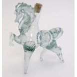 Manner of Murano : a hollow aqua glass decanter in the form of a prancing horse.