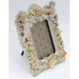 Late 20thC / early 21stC photograph frame decorated with ceramic cherubs,