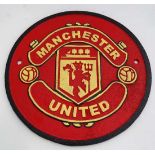 A 21stC painted cast metal round "Manchester United" sign 9 1/2 diameter CONDITION: