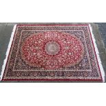 Carpet / Rug : a Keshan machine made red ground carpet, having central medallion ,