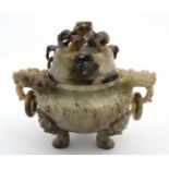 A Jade three footed censor with dragon mask handles and lid with further dragon decoration.