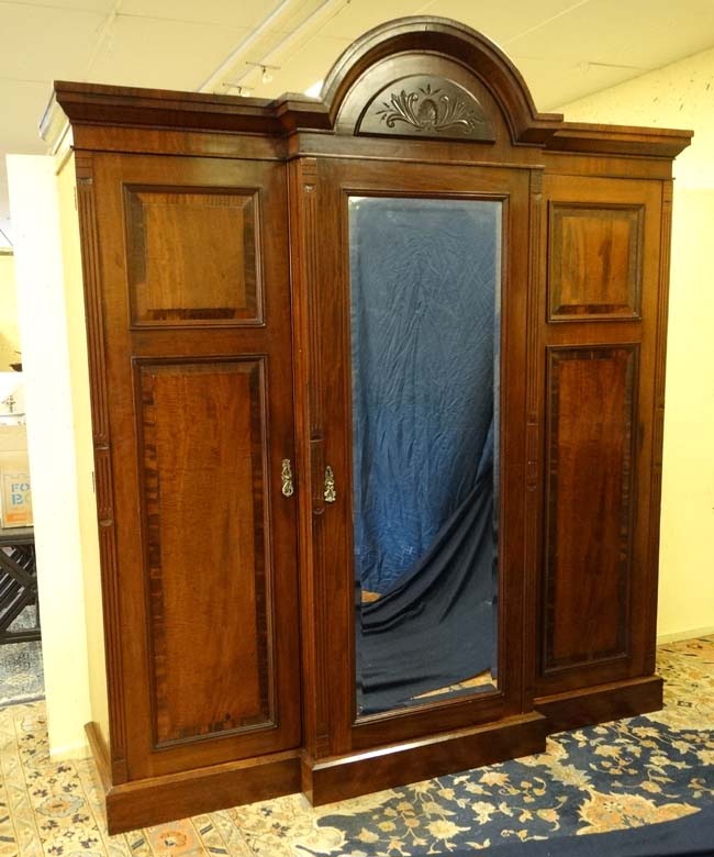 A 19thC mahogany breakfront triple wardrobe with central section with drawers and linen sides 94"
