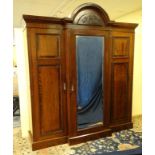 A 19thC mahogany breakfront triple wardrobe with central section with drawers and linen sides 94"