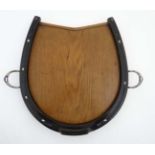 A c.1900 oak horseshoe formed tray with stirrup formed handles.