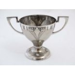 WMF : An Art Deco silver plate pedestal cup with two handles. marked under.