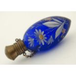 Scent bottle : a hinge lidded blue glass scent flask with hand painted enamel floral decoration,