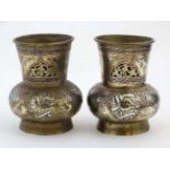 A 19thC pair of fine Indian bellied short vases with copper and silver inlay .